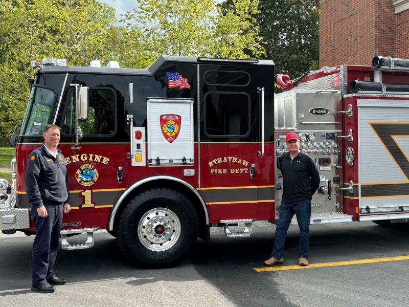 Two men next to Engine 1. 